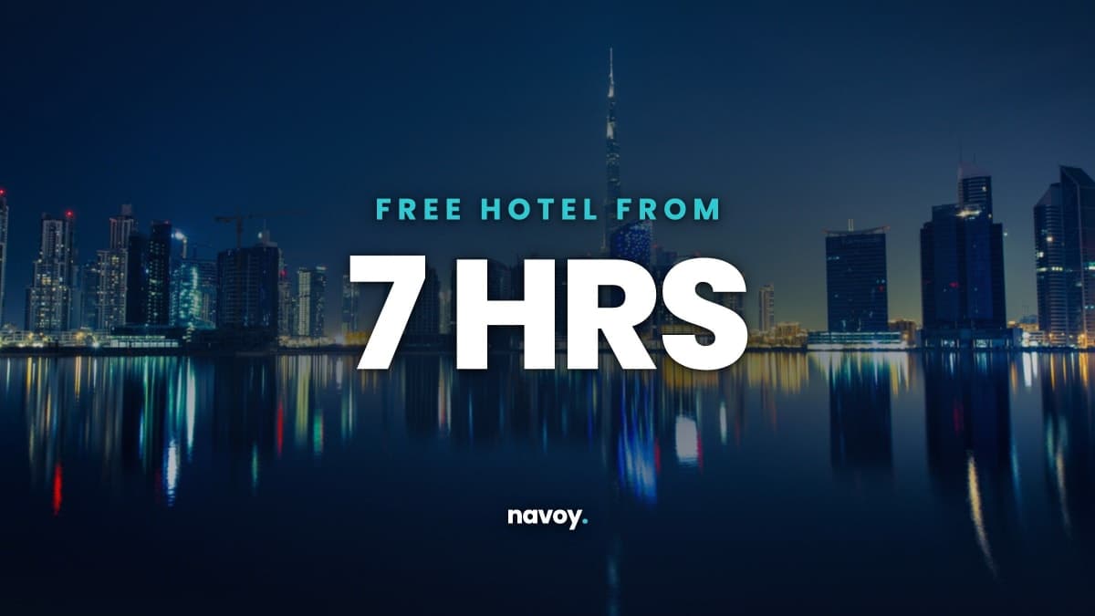 Dubai skyline at blue hour with headline Free hotel from 7 hrs, the lowest free layover hotel threshold in 2026