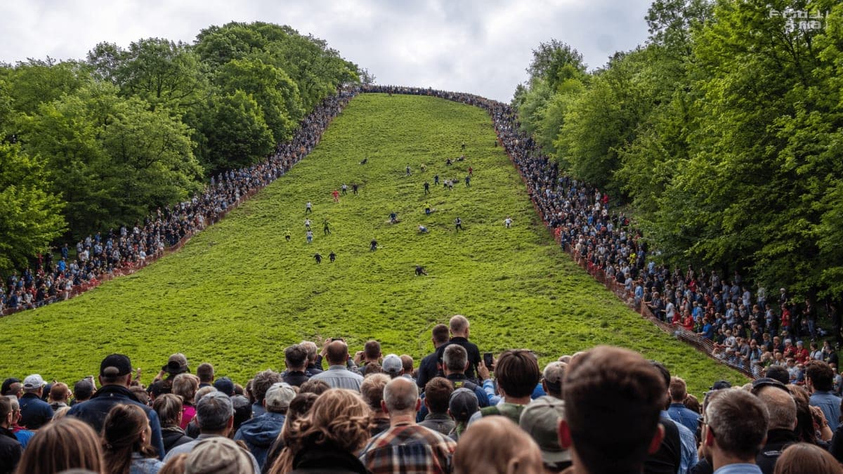 Cheese Rolling Festival 2027 crowds on the steep slope of Cooper's Hill in Gloucestershire