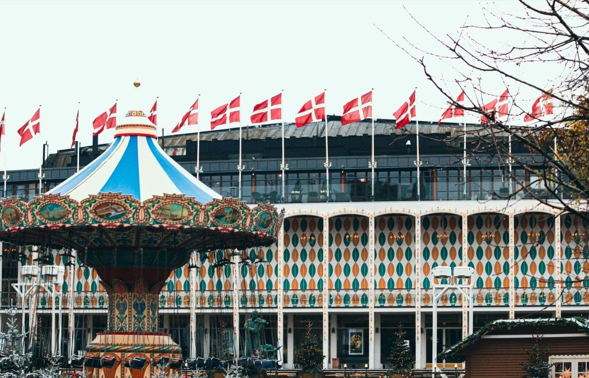 Tivoli Gardens carousel beside Christmas trees in Copenhagen