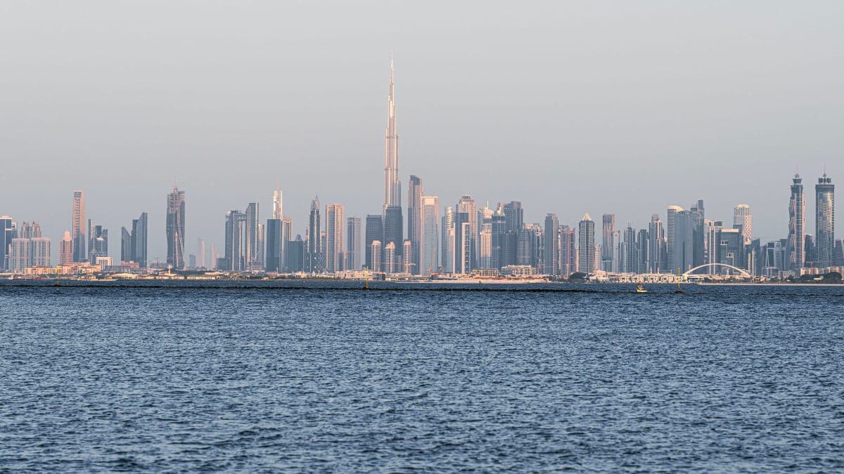 The Dubai skyline with the Burj Khalifa seen across calm blue water