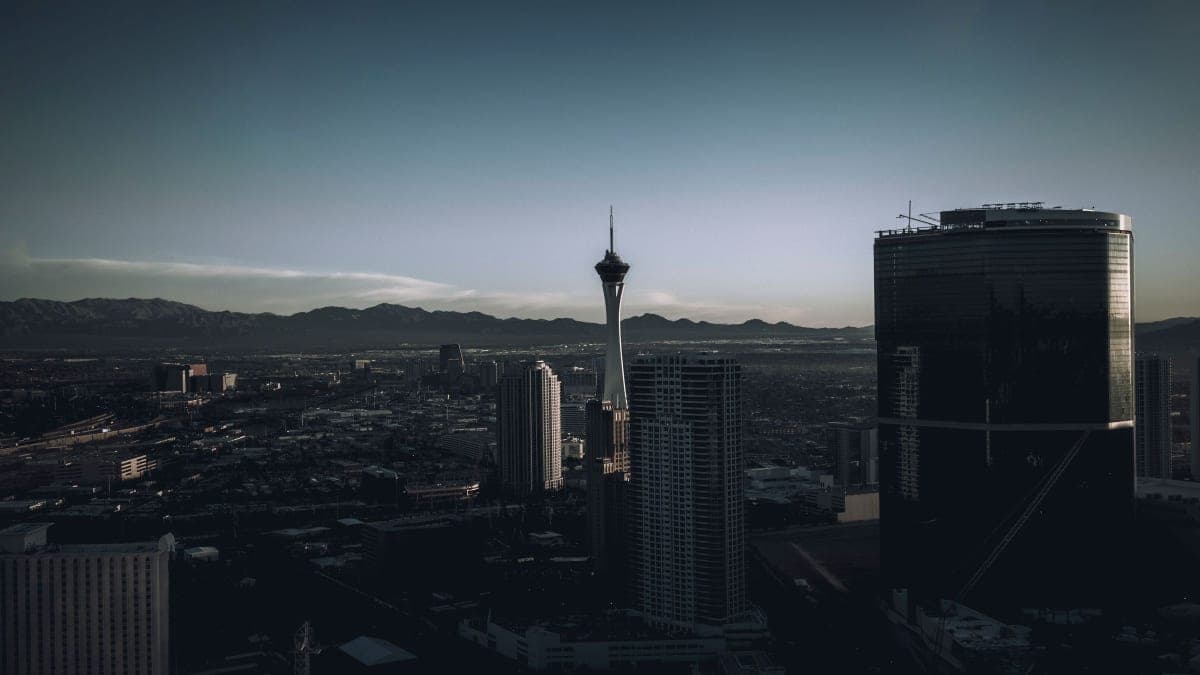 The Las Vegas skyline at dusk with the Strat tower and the desert mountains behind it