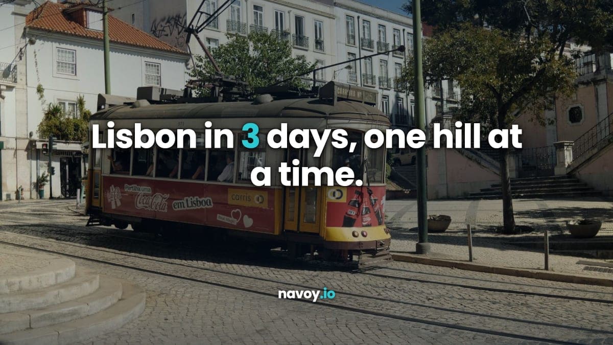 A classic yellow Lisbon tram on cobbled tracks in a sunlit street lined with trees and pale buildings