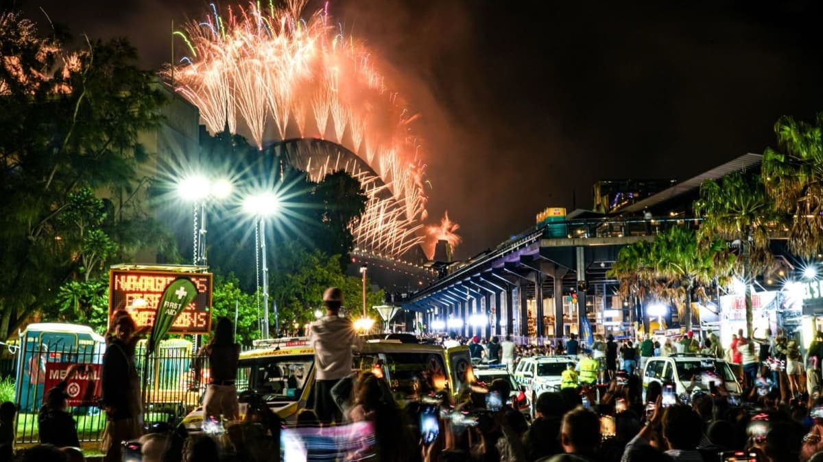 New Year's Eve fireworks over the Sydney Harbour Bridge, watched by crowds on the Circular Quay foreshore