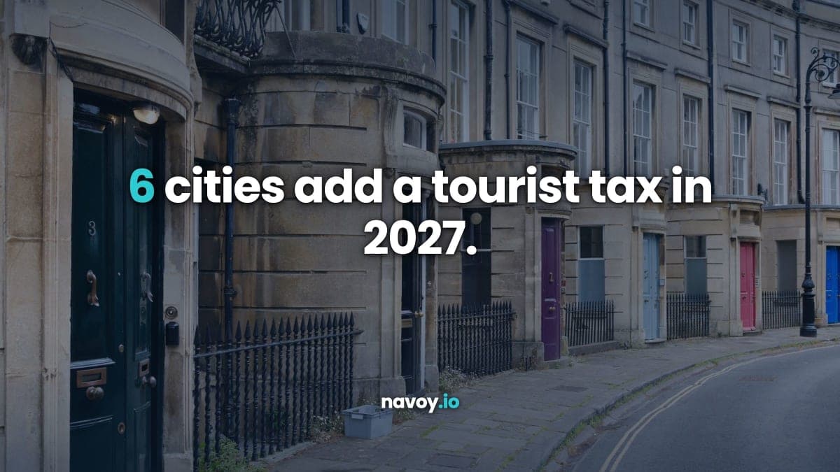 A row of Georgian townhouses on a UK city street in daylight, headlined 6 cities add a tourist tax in 2027