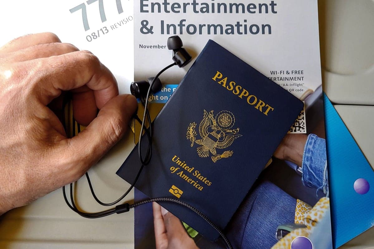 US passport and headphones on an airline seat before a flight to London