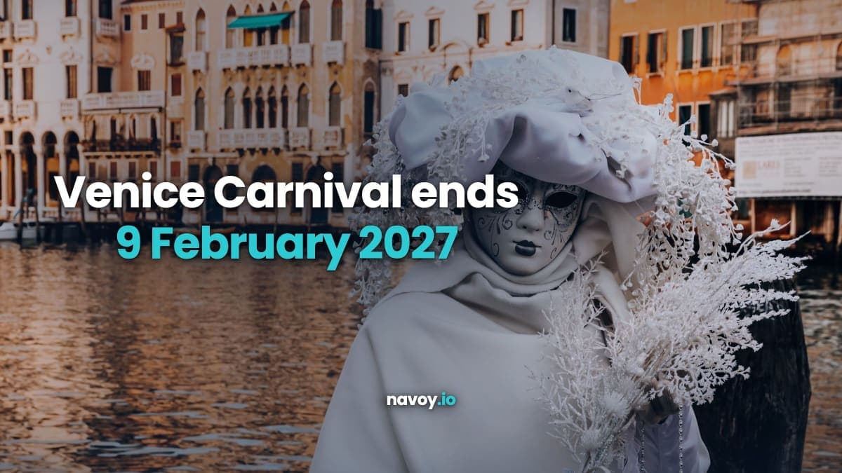 Person in an ornate white Venetian carnival mask and costume beside the Grand Canal in Venice