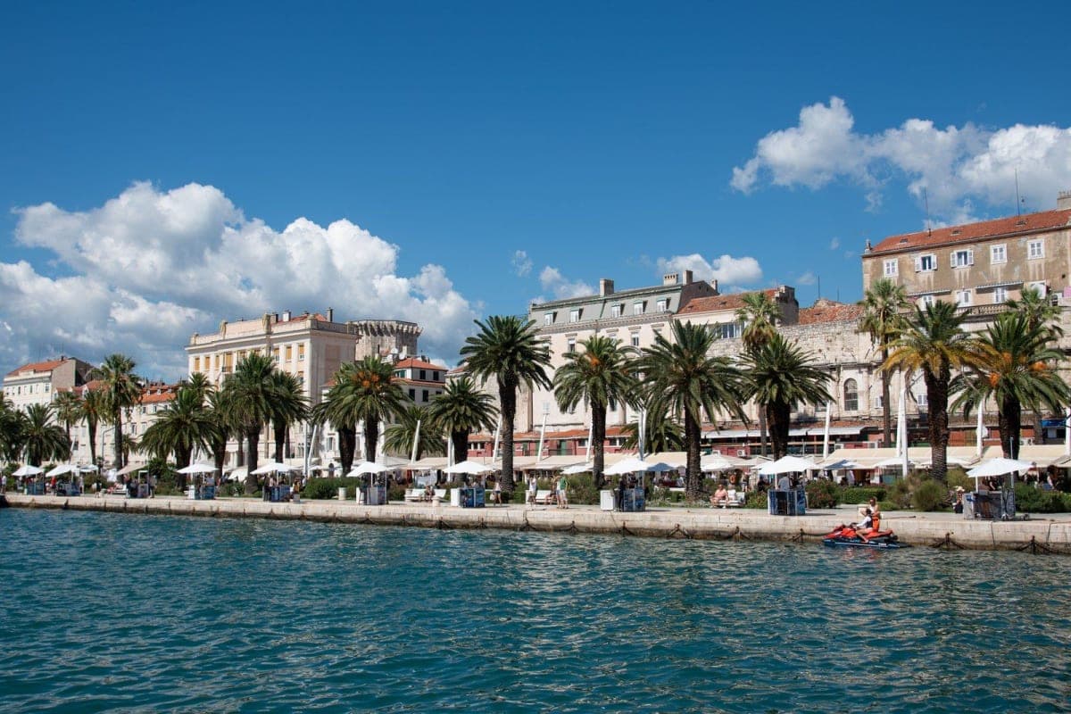 Split's palm-lined Riva promenade and old town buildings seen from the Adriatic